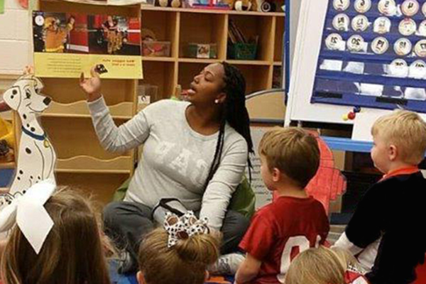 Student Teacher reading to students in classroom.